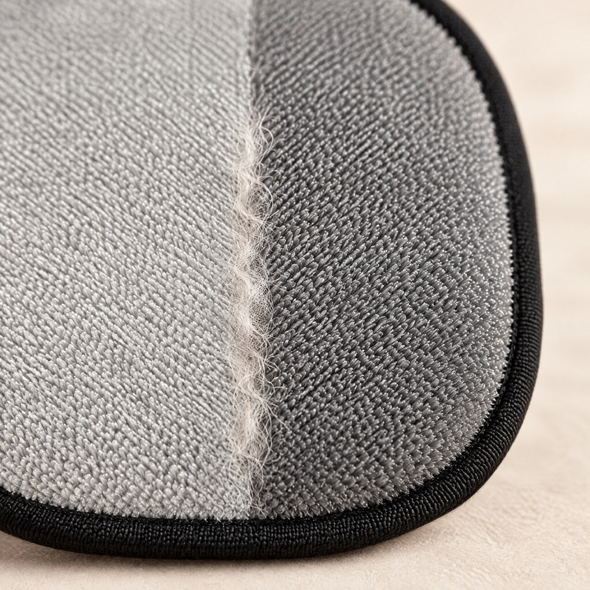 Close-up of the gray two-way bristles meeting at the center seam, with a line of gathered pet hair