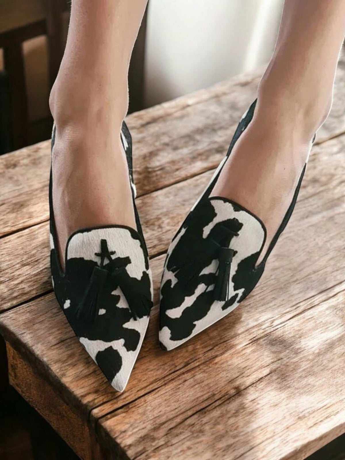 Noor | Cow Print Pointed Tassel Loafers, colour Black